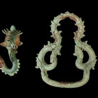 Image of two jewelry items, a hook and a ring against a black backdrop